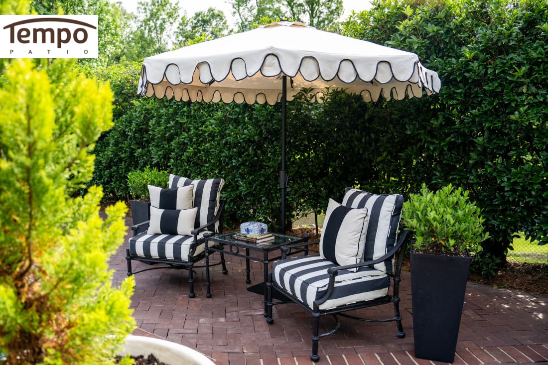Portable patio umbrella solutions featuring a scalloped market umbrella over a black and white seating area.