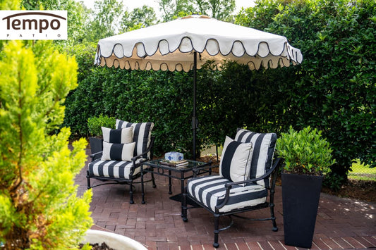 Portable patio umbrella solutions featuring a scalloped market umbrella over a black and white seating area.