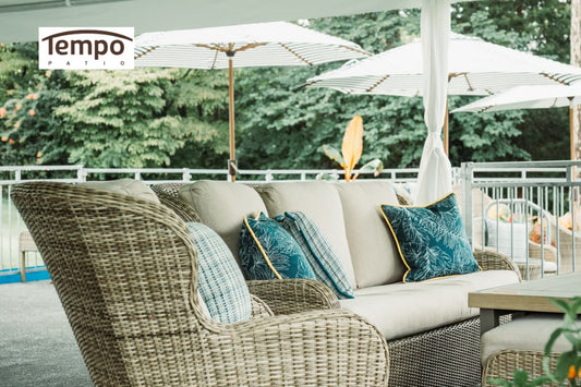Wicker patio seating beneath striped umbrellas, showcasing semi-permanent & fixed umbrella setups