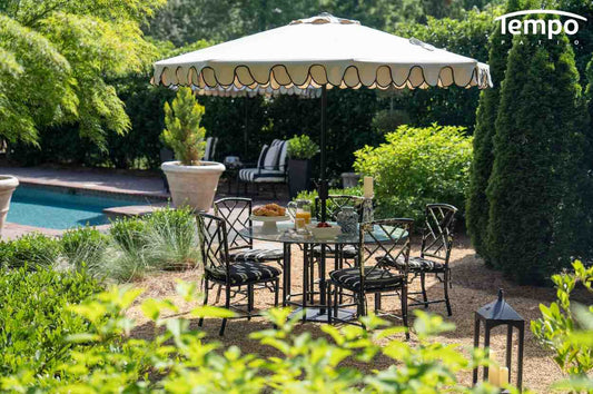 Umbrella shade vs pergola effectiveness featuring scalloped white market umbrella over garden dining set&nbsp;