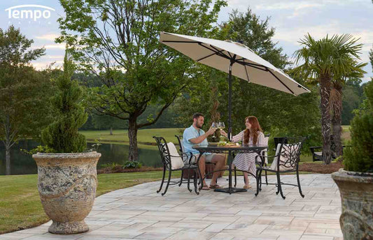When umbrellas are better than awnings: couple enjoying wine at an outdoor table shaded by a patio umbrella