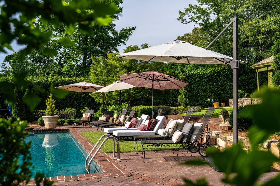 Elegant poolside seating area with layered umbrellas and greenery, shown in a basic guide to patio umbrellas outdoors for balanced sun protection and style.