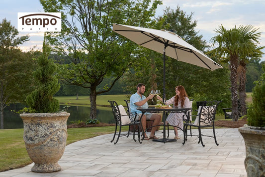 Couple dining under a cream umbrella, demonstrating choosing permanent patio umbrellas easily for outdoor living