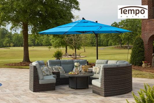 Guide to fixed base patio umbrellas featuring a blue cantilever umbrella over wicker sectional seating.