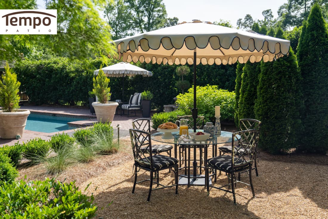 Guide to portable patio umbrella buying shown with a decorative scalloped umbrella over a garden dining area.