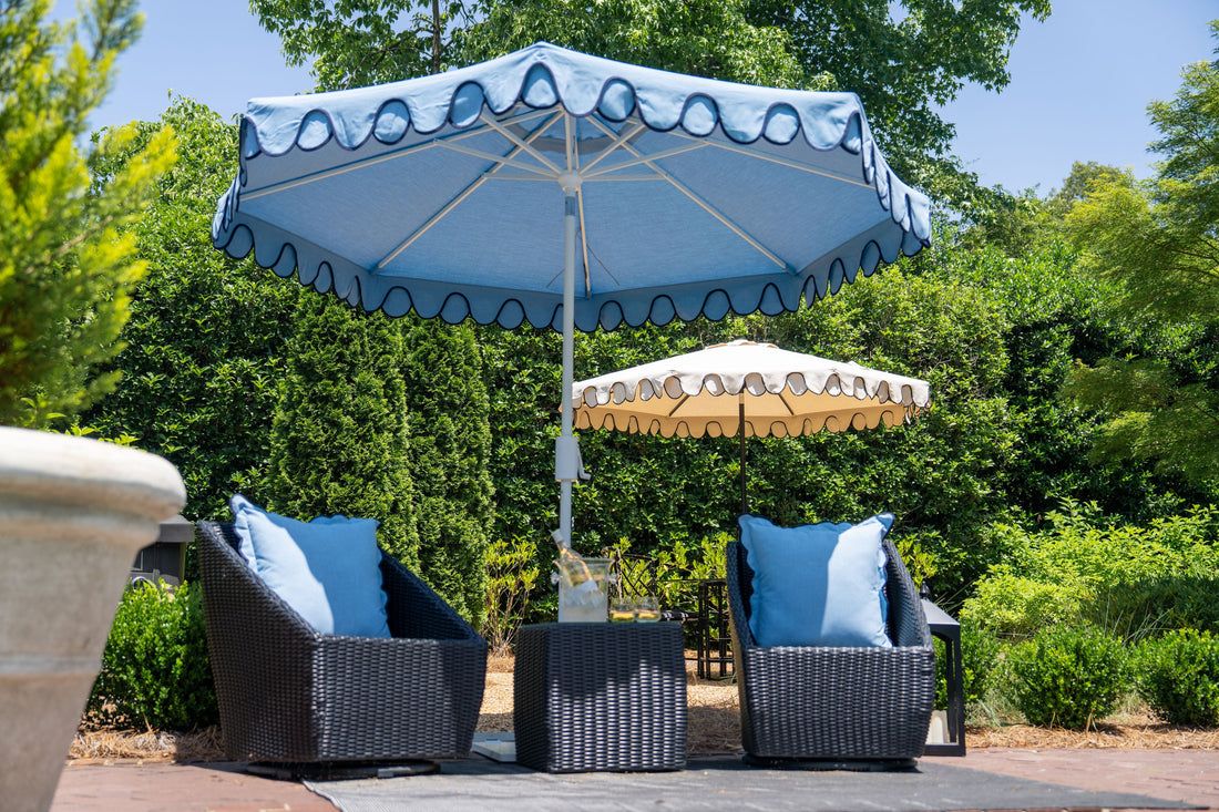 Patio seating area with a decorative blue umbrella overhead, demonstrating how patio umbrellas provide shade safely for outdoor relaxation on warm days.