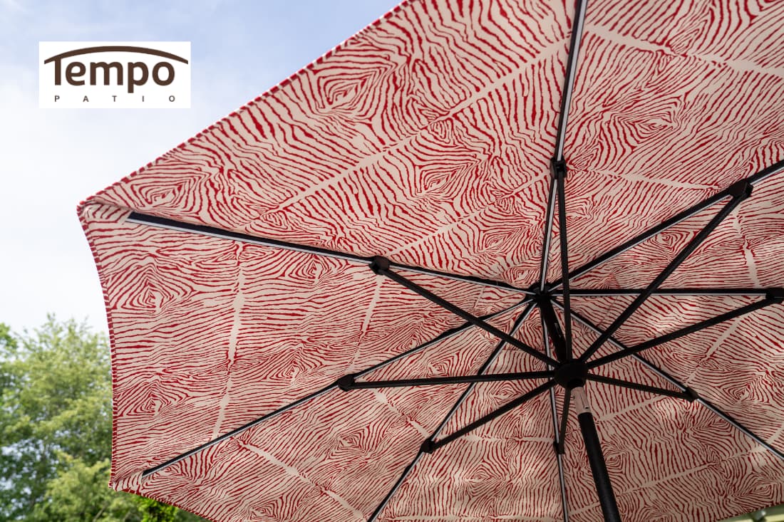 Lightweight movable patio umbrella options include a red zebra-print canopy viewed from below