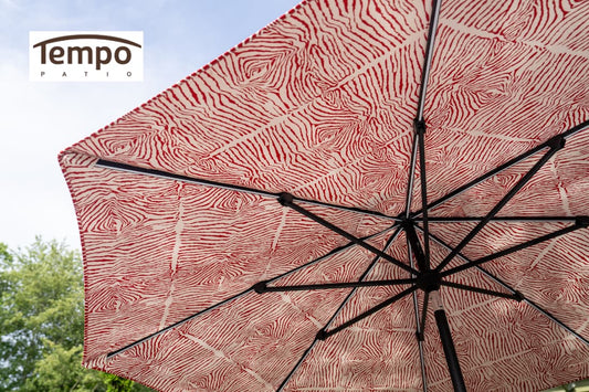 Lightweight movable patio umbrella options include a red zebra-print canopy viewed from below