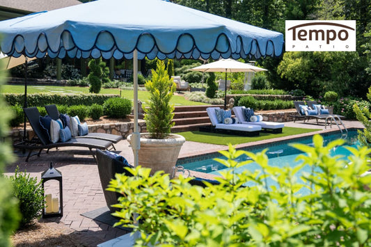 Portable umbrella vs gazebo overview with multiple patio umbrellas covering loungers around a landscaped pool.
